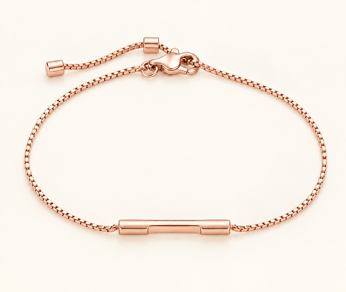 A rose gold chain bracelet with a polished horizontal bar at the center and an adjustable sliding clasp, shown on a clean off-white background.