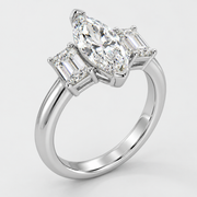Three stone marquise and emerald cut diamond engagement ring in white gold