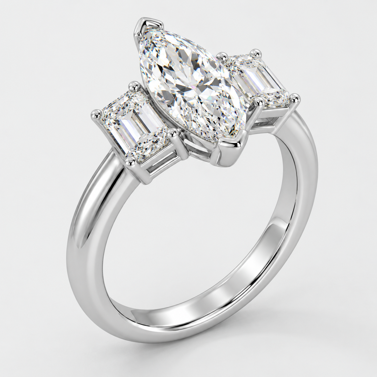 Three stone marquise and emerald cut diamond engagement ring in white gold