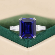 Emerald cut blue sapphire engagement ring with moissanite side stones