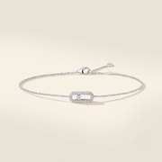 18K white gold diamond pavé bracelet with moving diamond motif on ivory background
