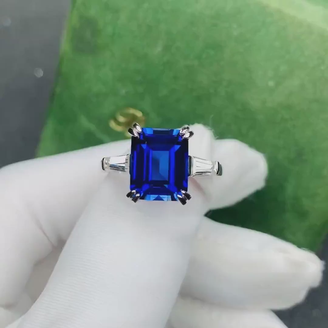 Emerald cut blue sapphire engagement ring with moissanite side stones